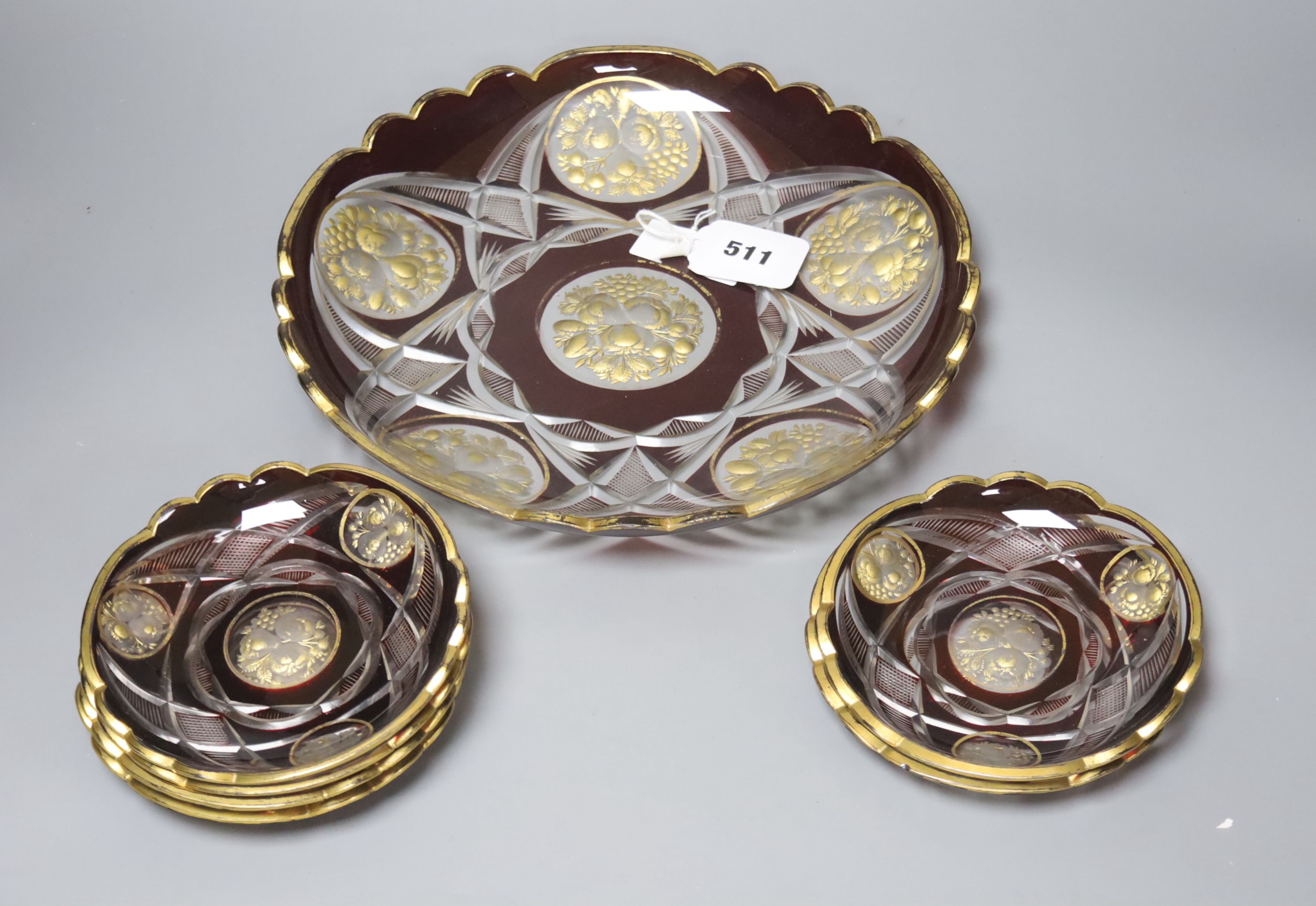 A late 19th century Bohemian intaglio cut and gilded glass dish and six saucers